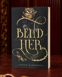 Bend Her black-and-gold foil paperback in an oxblood editorial setting